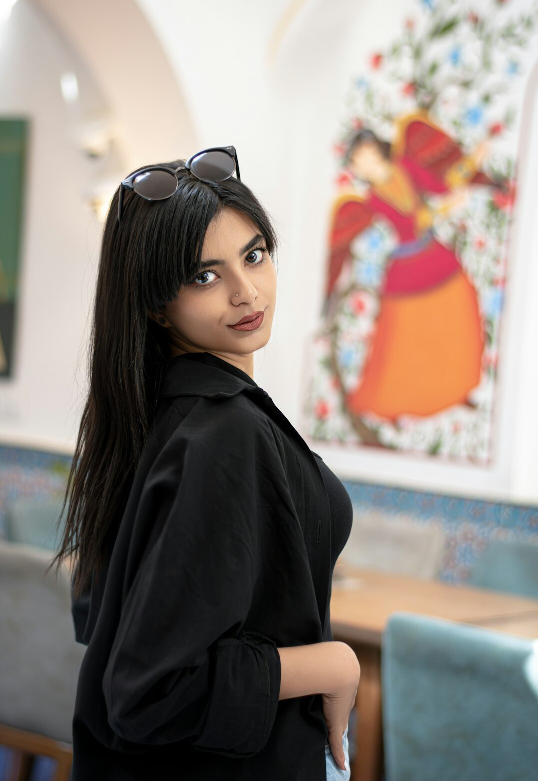 Portrait of a smiling woman with dark hair in a blazer
