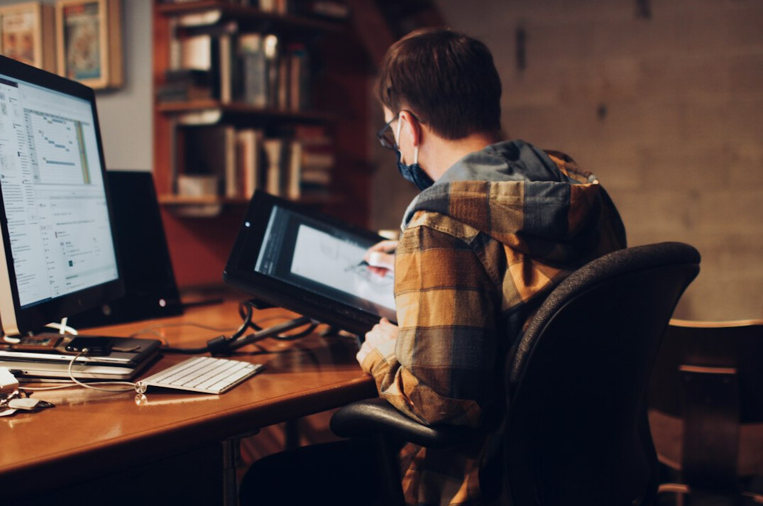 young programmer coding at desk