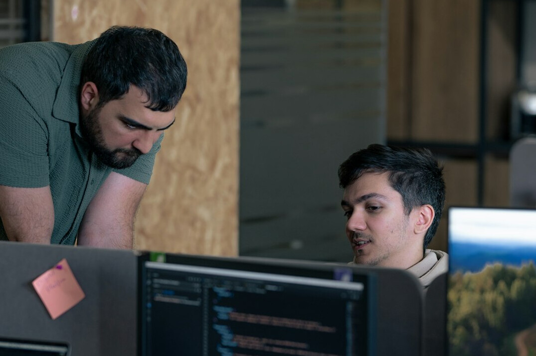 mentor teaching coding to students